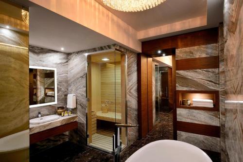 a bathroom with a tub and a sink and a toilet at Constantine Marriott Hotel in Constantine