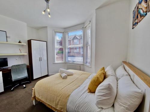a bedroom with a bed and a desk and window at Incredible Private Rooms All with Private Bathrooms in a Fully Serviced House next to City Centre with Free Parking in Coventry