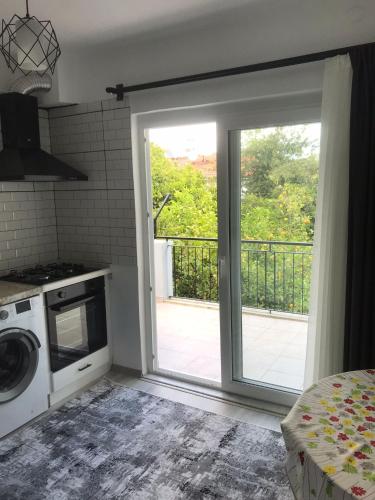 a kitchen with a sliding door to a balcony at Backyard Apart in Kemer