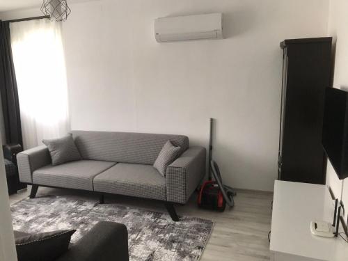 a living room with a couch and a air conditioner at Backyard Apart in Kemer