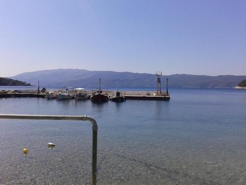 a dock on a lake with boats in the water at Iriana Village Inn in Stavros