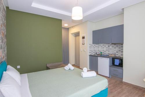 a bedroom with a large bed with towels on it at Verga's Apartments in Kalamata