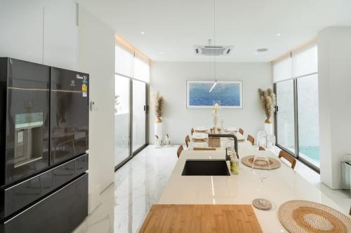 a living room with a large kitchen with a large appliance at The Residence by Andaman Phuket in Ban Mut Dok Khao
