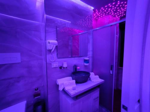 a purple bathroom with a sink and a mirror at B&B MaisonAlysie in Foggia