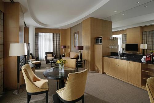 uma sala de estar com mesa e cadeiras e uma cozinha em Lugal, A Luxury Collection Hotel em Ancara