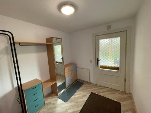a room with a closet with a mirror and a door at Ferienwohnung Maxi in Maishofen