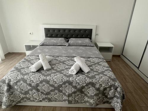 a bedroom with a large bed with two pillows at Marjana's Sea View Apartment 1 in Lezhë
