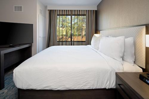 a hotel room with a large bed and a window at Residence Inn by Marriott Valencia in Valencia