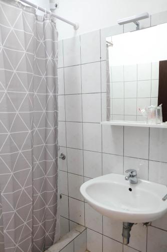 a white bathroom with a sink and a shower at Vila Nada in Prigradica