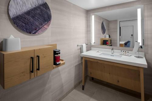 a bathroom with a sink and a mirror at Delta Hotels by Marriott Santa Clara Silicon Valley in Santa Clara