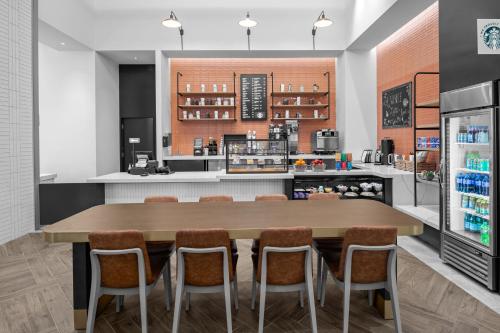a kitchen with a large wooden table and chairs at Delta Hotels by Marriott Santa Clara Silicon Valley in Santa Clara