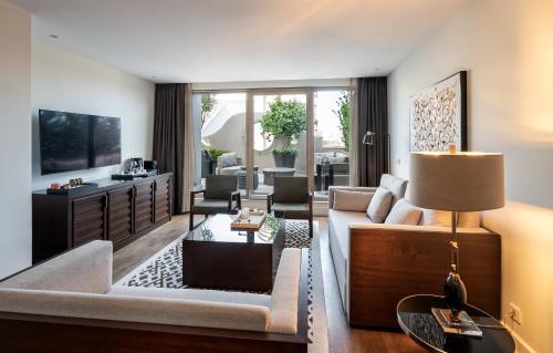 a living room with a couch and a table at The Stay Boulevard Nisantasi in Istanbul