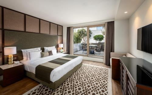 a bedroom with a large bed and a television at The Stay Boulevard Nisantasi in Istanbul