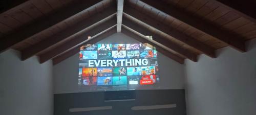 a television hanging from a ceiling in a room at Arcade central retro apartment in Rethymno Town