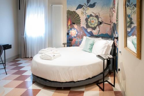 a bedroom with a large bed in a room at Palazzo Scappi Gardi Luxury Apartments in Bologna