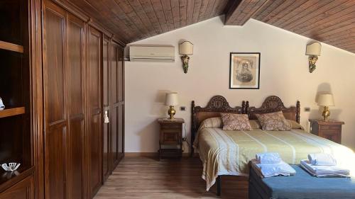 a bedroom with a bed and a bench in a room at SEA VIEW Apartment in Giardini Naxos