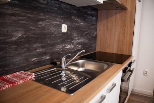 a kitchen with a sink and a counter top at Amber in the centar in Kaštela
