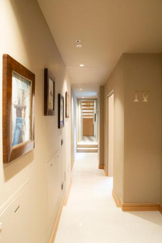 a hallway with paintings on the walls and a painting on the wall at Palazzo Scappi Gardi Luxury Apartments in Bologna