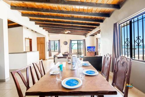 a dining room with a wooden table and chairs at InTown Beach front condo - Casey`s condo 1 in San Felipe