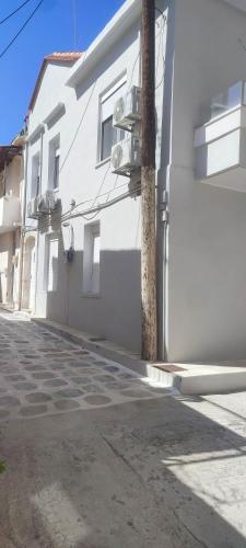 a white building on the side of a street at Arcade central retro apartment in Rethymno Town