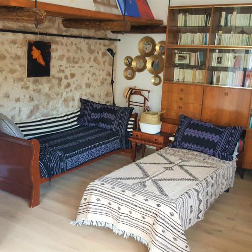 a living room with two beds and a couch at Little house with a large roof garden in the city center in Marseille