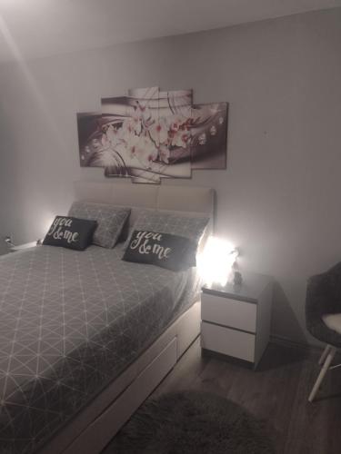 a bedroom with a bed and a table with a lamp at Mare kuća za odmor in Šibenik