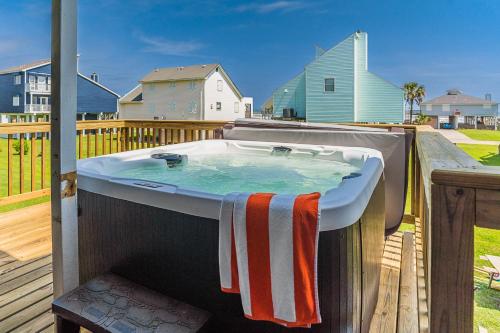 a bath tub with a towel on a deck at Hot Tub - Ocean Views - Steps to Private Beach - Quiet Location in Galveston