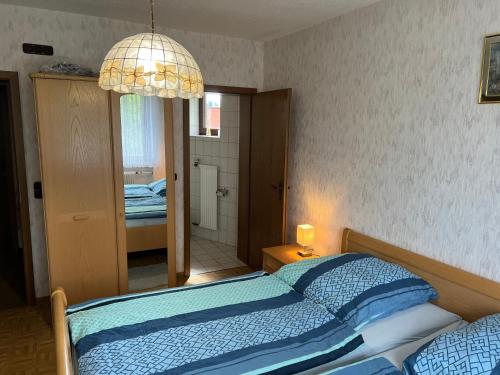a bedroom with a bed and a light fixture at Doppelzimmer Nr 4 in Freiensteinau