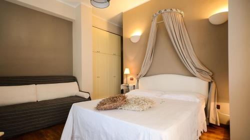 a bedroom with a white bed with a canopy at Terre del Sud in Locri