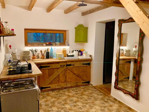 a kitchen with wooden cabinets and a counter top at Hacienda Verde in Szentes