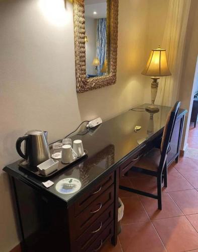a desk with a tea kettle on top of it at Porto Marina Patio Suite - Egyptian Residents Only in El Alamein
