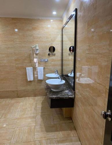 a bathroom with a sink and a glass shower at Porto Marina Patio Suite - Egyptian Residents Only in El Alamein
