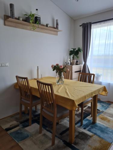 a dining room with a wooden table and chairs at FLOWER HOUSE in Hvolsvöllur