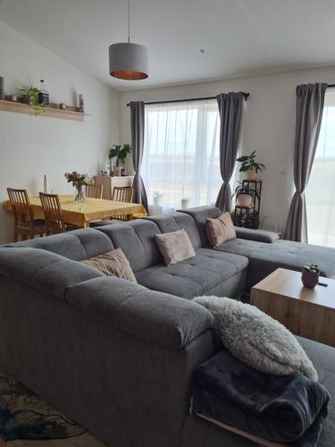 a living room with a gray couch and a table at FLOWER HOUSE in Hvolsvöllur