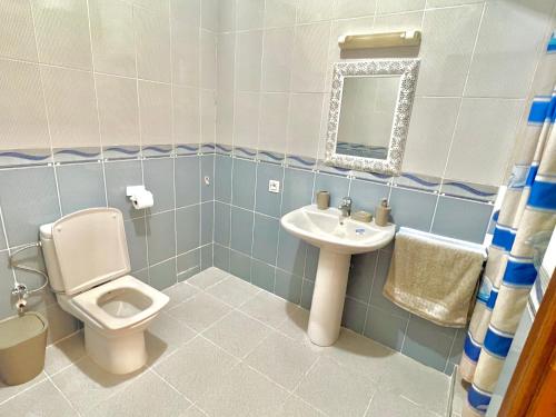 a bathroom with a toilet and a sink at Joli appartement a la corniche de Tanger in Tangier