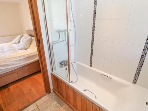 a bathroom with a shower and a bath tub at Swallows Rest in Hexham