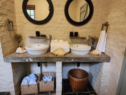 a bathroom with two sinks and two mirrors at 8 at Norman Crescent in Johannesburg