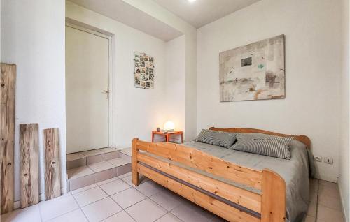 1 dormitorio con 1 cama con marco de madera en 1 Bedroom Lovely Apartment In Saint-etienne, en Saint-Étienne