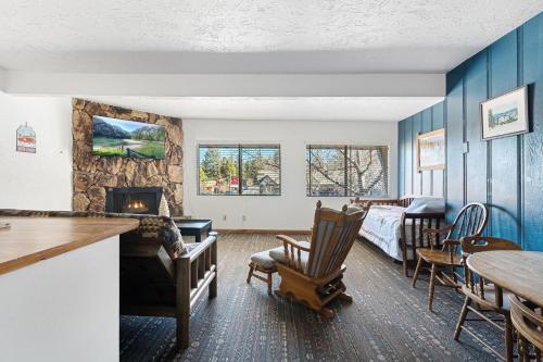 a living room with a bed and a fireplace at 02- American Black Bear At Village Suites Inn in Big Bear Lake