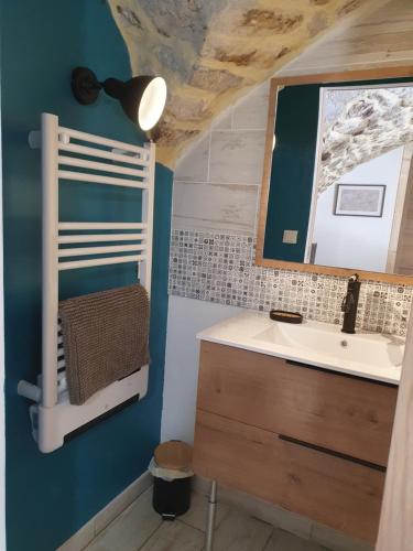 a bathroom with a sink and a mirror at La Storya in Meyras