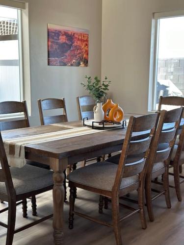 a dining room table with chairs and a table with a pumpkin on it at Grand Canyon-4bed,3bath,hot tub in Hildale