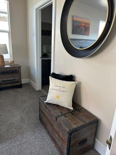 a pillow sitting on a chest in a room with a mirror at Grand Canyon-4bed,3bath,hot tub in Hildale