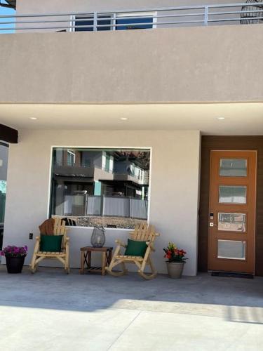 two chairs and a table in front of a building at Grand Canyon-4bed,3bath,hot tub in Hildale
