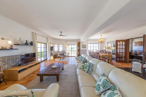 a living room with a couch and a table at Casa do Mar Beach & Country Algarve in Lagoa
