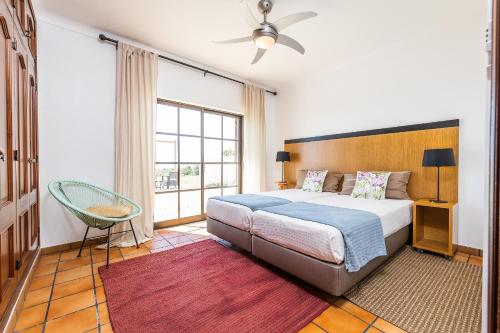 a bedroom with a bed and a large window at Casa do Mar Beach & Country Algarve in Lagoa