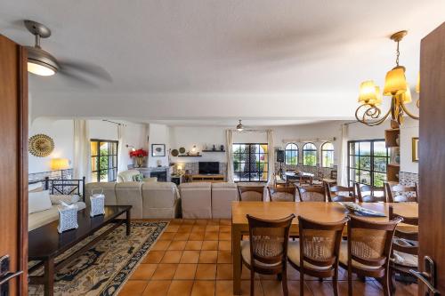 a dining room and living room with a table and chairs at Casa do Mar Beach & Country Algarve in Lagoa