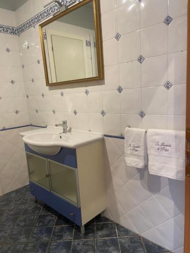 een badkamer met een wastafel, een spiegel en handdoeken bij La lavanda di Poppi-mini appartamento in Poppi