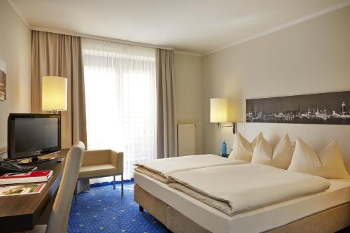 Postel nebo postele na pokoji v ubytování H4 Hotel Hamburg Bergedorf