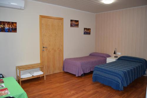 a hotel room with two beds and a door at Habitación independiente II en Casa Rural Javier in Valmuel