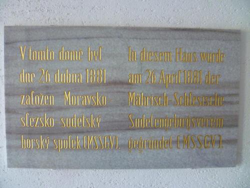 a sign on a wall with words in different languages at Hotel Koruna in Jeseník
